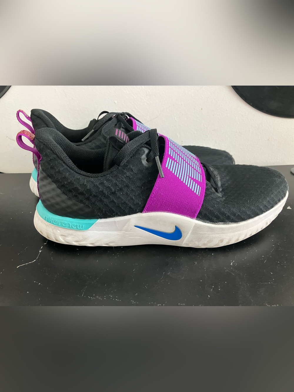 Nike Black Athletic Shoes with Purple Strap and Blue Swoosh
